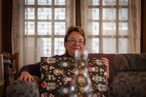 Merilee Miller opening a present